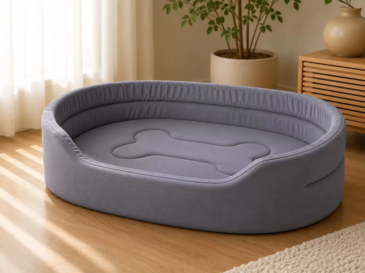 Grey Cozy Pet Mattress Bed with raised cushioned sides and bone-shaped padded center on a wooden floor in a bright modern living room for dogs and cats.