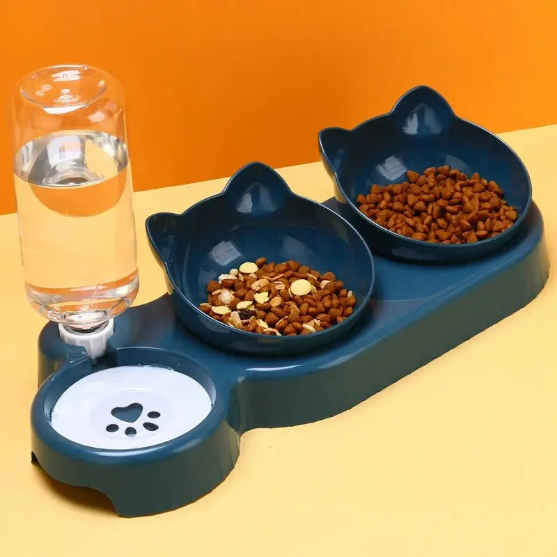 Pet feeding station with two bowls of food and a glass of water on an orange background